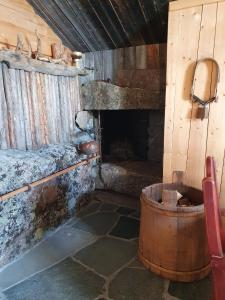 a room with a fireplace and a barrel at Hytte i Hallingdal/Flå in Flå