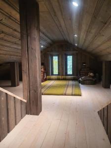 a large room with a wooden floor and windows at Hytte i Hallingdal/Flå in Flå