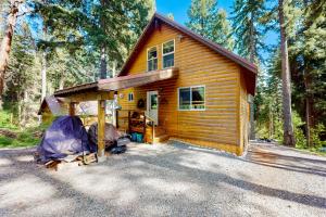 a log cabin with a tent in front of it at Pine-Loch Sun Retreat in Ronald