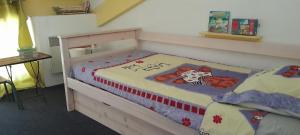a bedroom with a bed with a teddy bear on it at gite Sous le Figuier in Vals-les-Bains