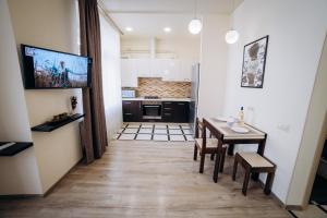a kitchen and dining room with a table and chairs at Family House in Vinnytsya