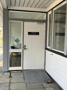 a white garage door with a sign on it at Reine City Apartment in Reine