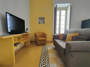 a living room with a couch and a flat screen tv at Dimora del Sole in Martina Franca