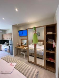 a bedroom with a bed and a large mirror at Sea Side Apartments & Studios-Renovated in Tsilivi