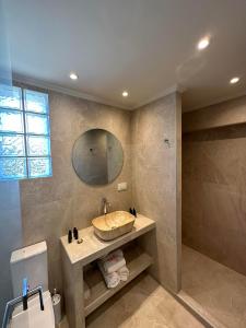 a bathroom with a sink and a mirror at Sea Side Studios in Tsilivi