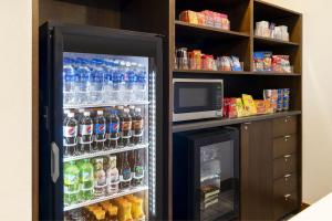 a refrigerator filled with lots of bottles of water at Four Points by Sheraton Tucson Airport in Tucson