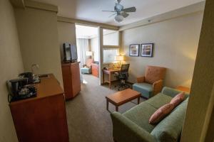 uma sala de estar com um sofá e uma televisão num quarto de hotel em Courtyard by Marriott St. John's Newfoundland em St. John's