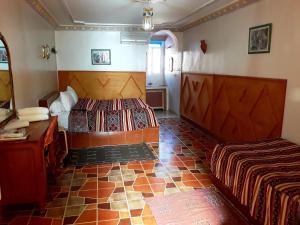 Ένα ή περισσότερα κρεβάτια σε δωμάτιο στο Ksar Timnay Hotel