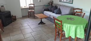 a living room with a table and a couch at gite Sous le Figuier in Vals-les-Bains +9 photos