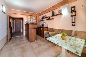 a room with a table and chairs and a counter at Camere de inchiriat CASA ROYAL in Eforie Nord +24 photos