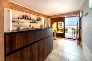 a kitchen with a large wooden bar with a view of the ocean at Camere de inchiriat CASA ROYAL in Eforie Nord