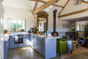 a kitchen with blue cabinets and a living room at Seaves Mill in York