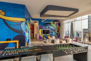 a living room with a mural on the wall at W Panama in Panama City