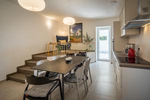 a kitchen and dining room with a table and chairs at Villa Skrila in Fažana