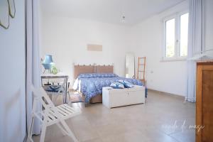 a bedroom with a bed and a desk and a ladder at Masseria Giangrande - Rooms and Apartment in Polignano a Mare