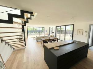 a living room with a staircase and a dining room at LA CASA SA TRINXA - 300 m des plages - Pointe de Beg-Meil in Fouesnant +68 photos