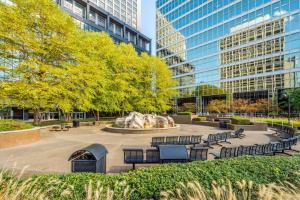 a park with benches and a fountain and buildings at CozySuites Dream 1BR, PPG Paints Arena, Pitts in Pittsburgh
