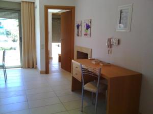 a room with a wooden desk with a chair in it at Maria Apartments in Agia Pelagia
