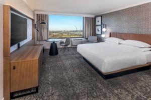 a hotel room with a large bed and a flat screen tv at Sheraton Pentagon City in Arlington +34 photos