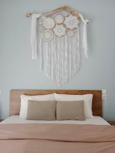 a headboard of a bed with a bunch of decorations on it at Olive - HappyHostGr - Downtown Apartment in Volos