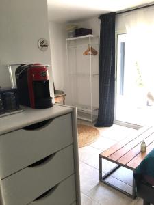 a kitchen with a microwave on top of a dresser at COSY ROOM PRIVATE BATH AND GARDEN in Anglet