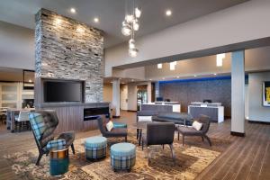 a hotel lobby with a fireplace and a tv at Residence Inn by Marriott La Quinta in La Quinta
