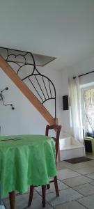 a room with a table with a green table cloth at gite Sous le Figuier in Vals-les-Bains