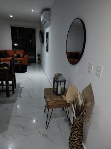 a living room with a table and a mirror at Astoria Gated Condos in Cancún