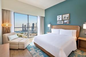a bedroom with a large bed and a large window at Element by Marriott Al Jaddaf, Dubai in Dubai +76 photos
