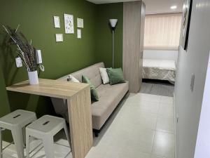 a living room with a couch and a table at Urban 102 in Manizales +2 photos