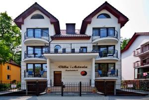 un gran edificio blanco con balcones. en Villa Astoria en Świnoujście