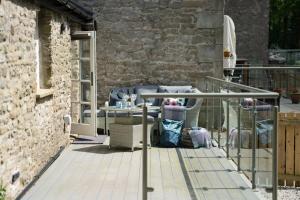 a patio with a couch and a table on a balcony at Contemporary Home by LetMeStay in Carnforth