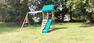 a playground with a slide in a park at Domaine de Marchal - chambres et table d'hôtes in Celles-sur-Durolle