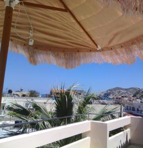 a view from a patio with a large umbrella at Maria Apartments in Agia Pelagia +12 photos