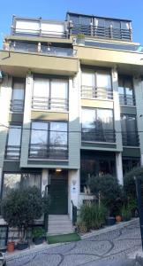 an apartment building with a green door and balcony at WILITTON BOSPHORUS HOUSE in Istanbul