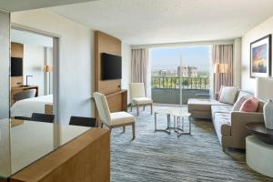 a hotel room with a bed and a living room at Warner Center Marriott Woodland Hills in Woodland Hills