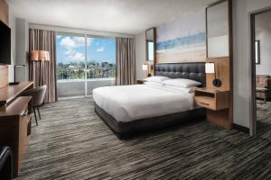 a hotel room with a bed and a large window at Warner Center Marriott Woodland Hills in Woodland Hills