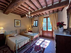 a bedroom with two beds in a room at Agriturismo Cima alla Serra in Buti