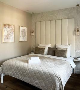 a bedroom with a large bed with a large headboard at Hotel Astoria The Hague in The Hague