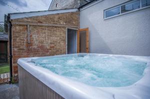 a large hot tub in front of a building at Rumwell Park - 8 Bedroom Manor House- Taunton in Taunton