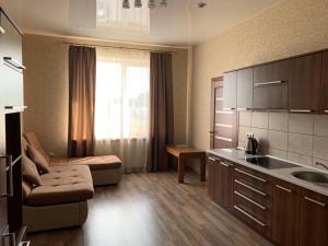 a kitchen and living room with a couch and a table at Hotel Resttime in Kovel