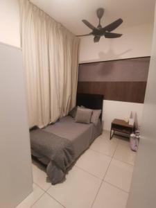 a bedroom with a bed and a ceiling fan at Mikael Homestay Kuala Lumpur in Kuala Lumpur