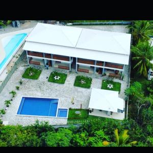 an aerial view of a building with a swimming pool at Casa noites tropicais in Imbassai