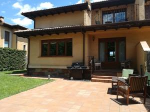 a house with a patio in front of it at Casa con jardín en Rascafría in Rascafría