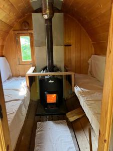 a room with a stove and two beds in it at ChillHouse in Loučná nad Desnou