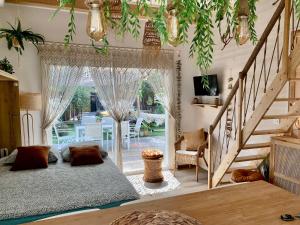 a living room with a bed and a staircase at Maisonnette avec terrasse et jardin-Parking privé-9mn des plages à pied in La Ciotat