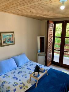 a bedroom with a blue bed with a tray on it at Aconchego Penedo in Penedo