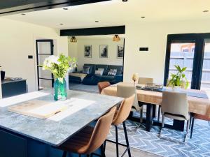 a living room with a table and chairs and a couch at The Ely Retreat in Ely