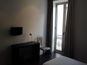 TV a/nebo společenská místnost v ubytování Lazza Hotel