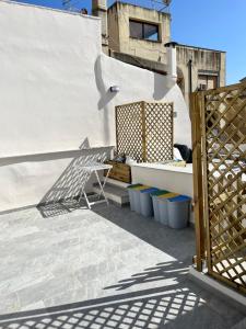 a patio with a chair and a table on a building at B&b AlgueRoof in Alghero